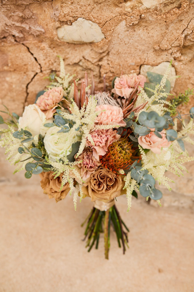 Bridal bouquet of blush, peach and cream flowers with eucalyptus