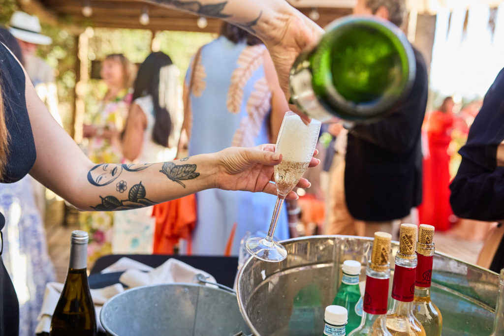 Bartender pouring a drink at the outdoor bar