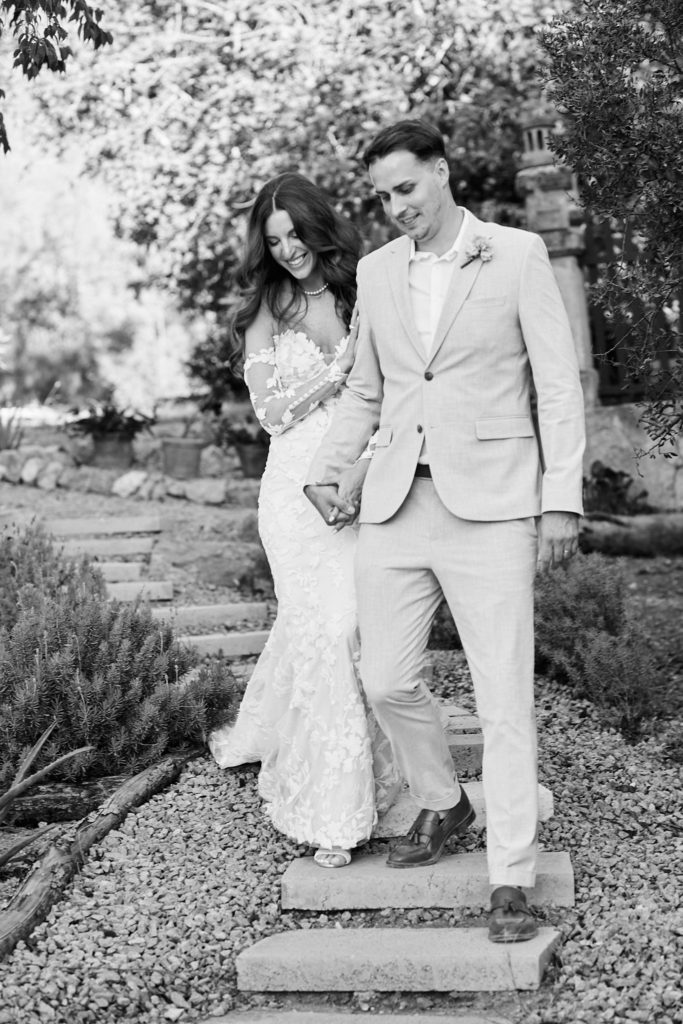 Black and white photo of the bride and groom coming down the garden steps at Son Boronat