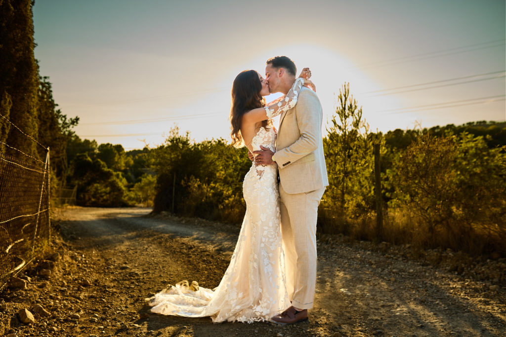 Bride and groom embracing on a country track at golden hour in Mallorca