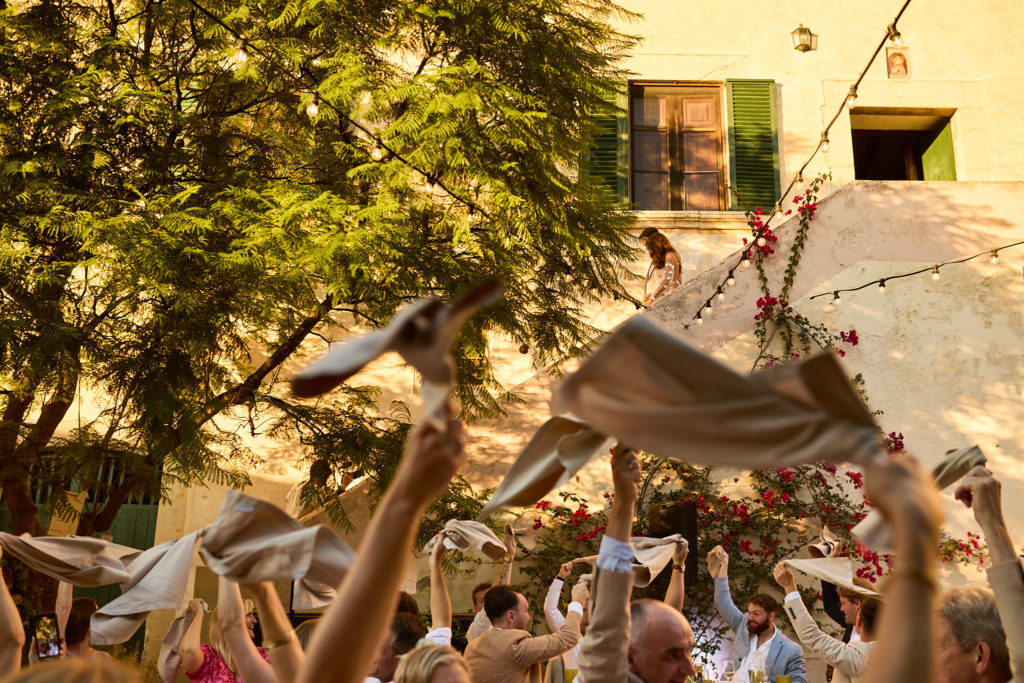 Wedding guests whirling napkins above their heads