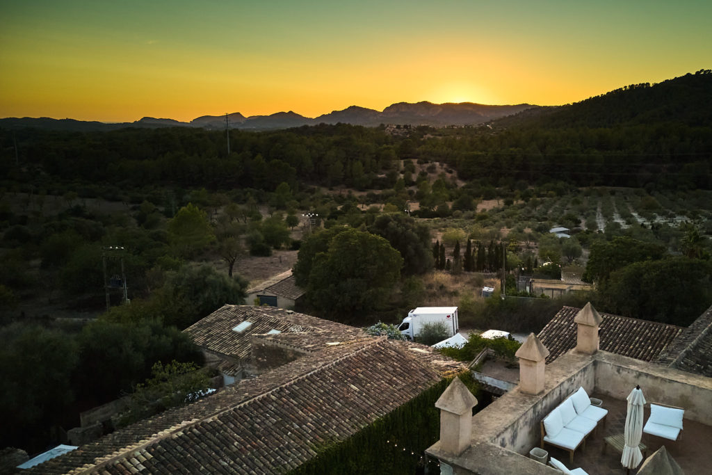 Aerial drone photo of Son Boronat at sunset with the Mallorcan mountains beyond