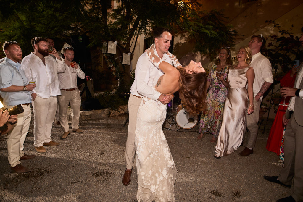 Bride and groom making their entrance to the evening party past cheering guests