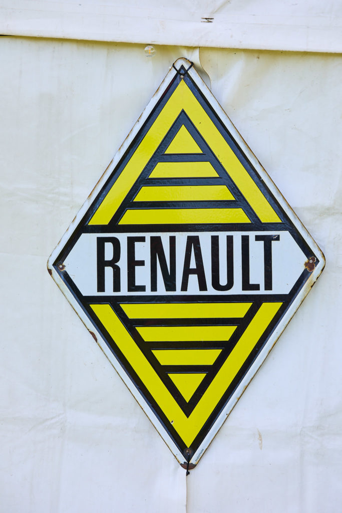Vintage yellow Renault diamond sign hanging on the marquee wall