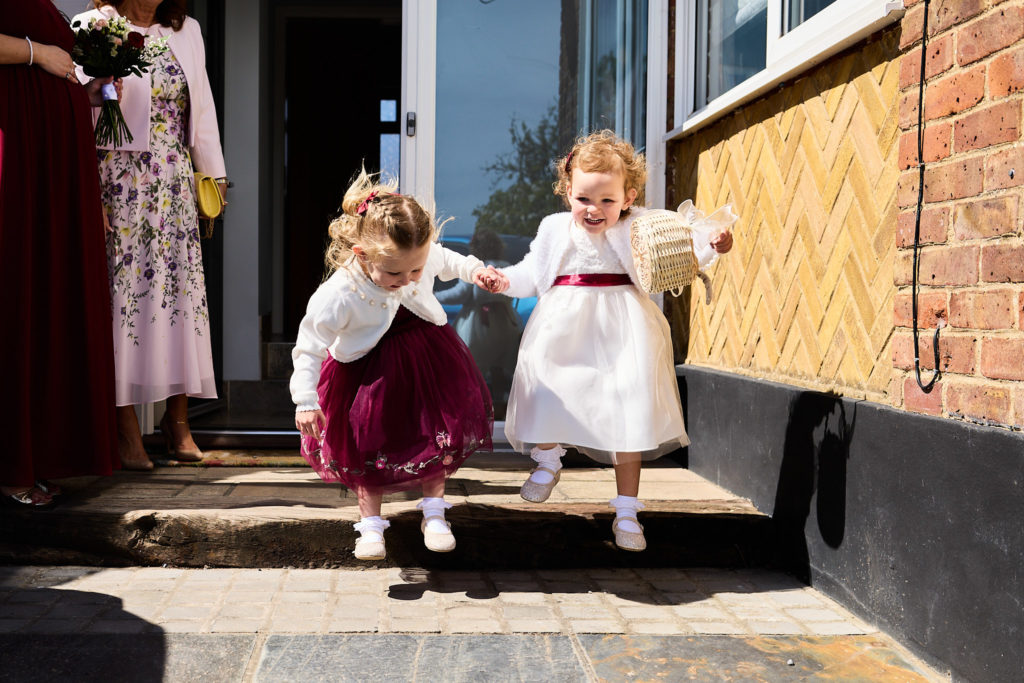 Flower girls running along a path in the sunshine