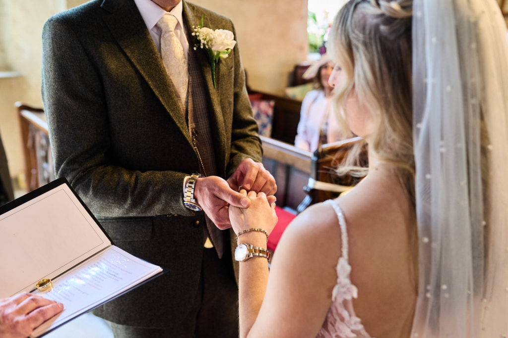 Close-up of the bride and groom exchanging wedding rings