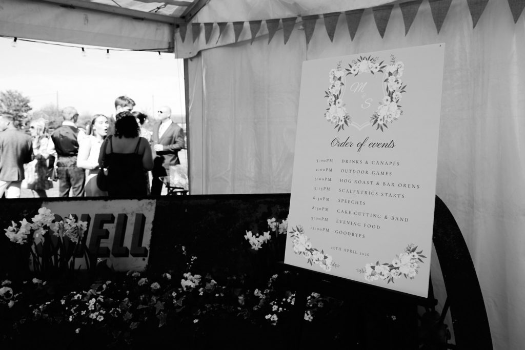 Black and white photo of the order of events sign at the marquee entrance