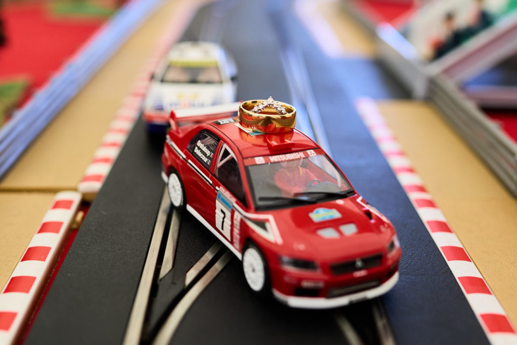 Red toy rally car on a Scalextric track