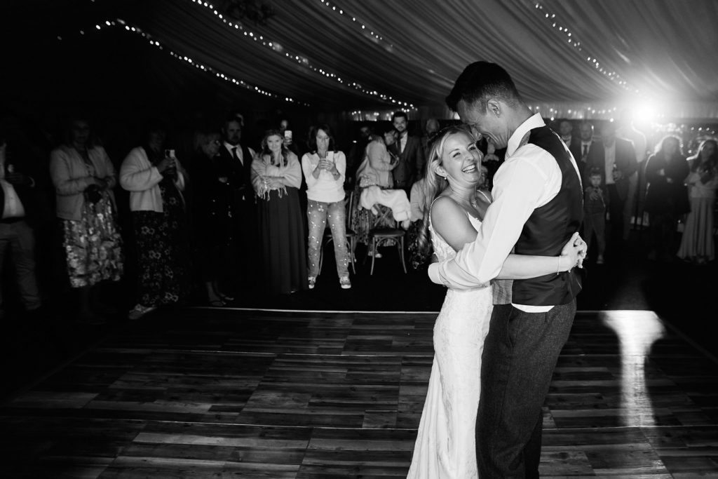 Black and white photo of the bride and groom's first dance in the marquee at South Fambridge