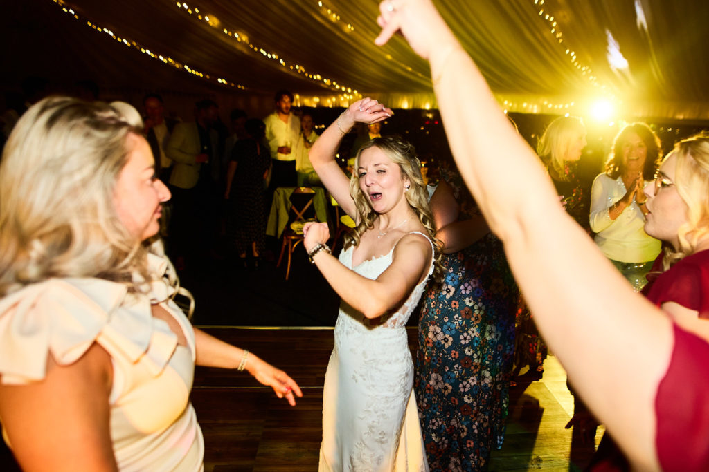 Wedding guests dancing with their arms in the air
