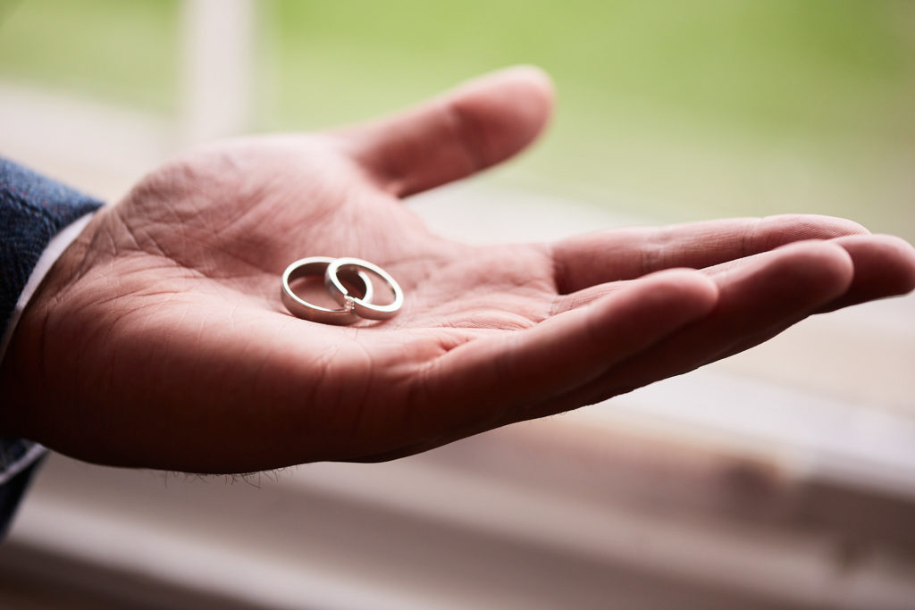 Wedding rings resting in the palm of a hand