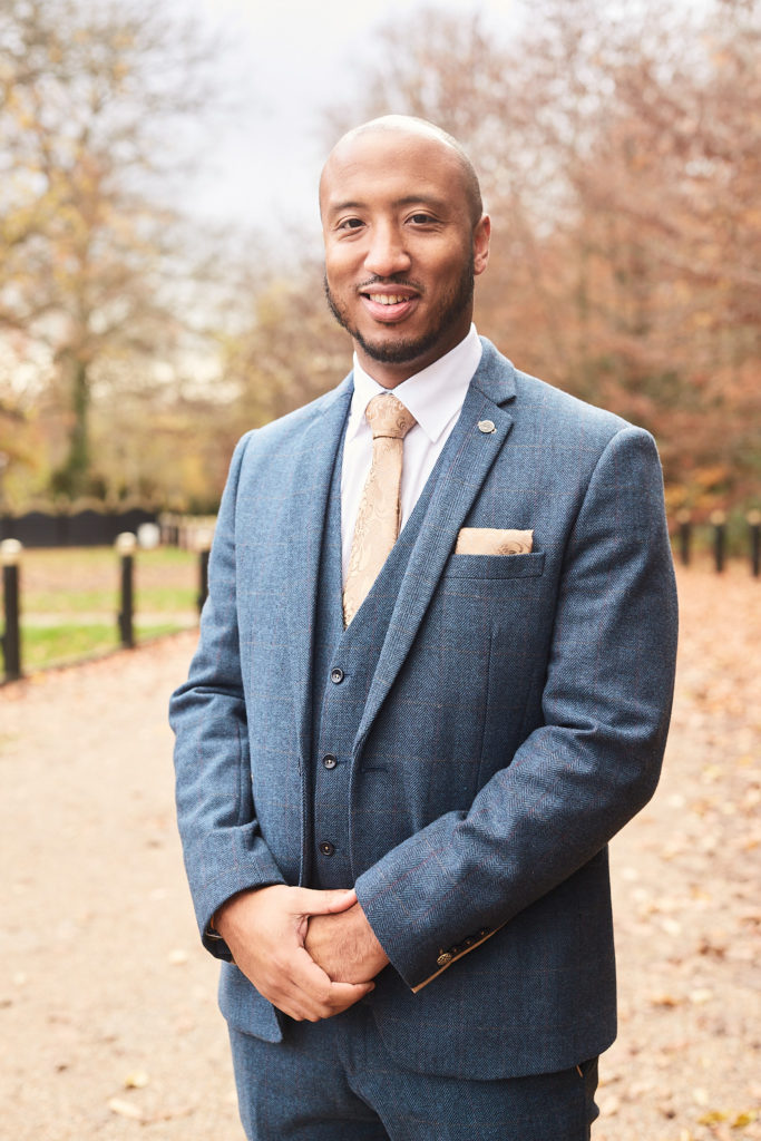 Groom in a blue tweed three-piece suit on the autumn drive at Addington Palace