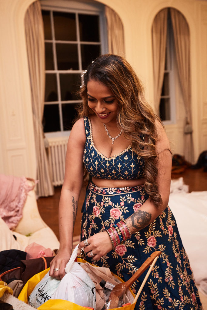 Bridesmaid in a navy embroidered lehenga getting ready