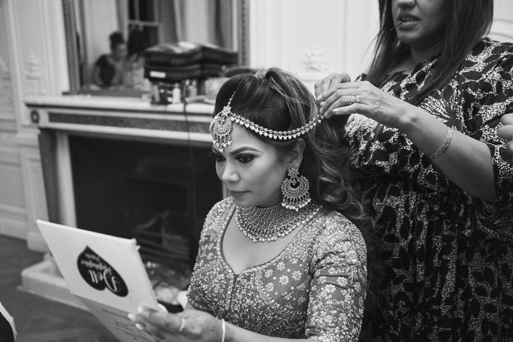 Black and white photo of the bride's headpiece being fitted