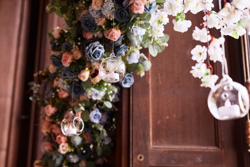 Flower garland of pink and blue blooms with a hanging glass bauble