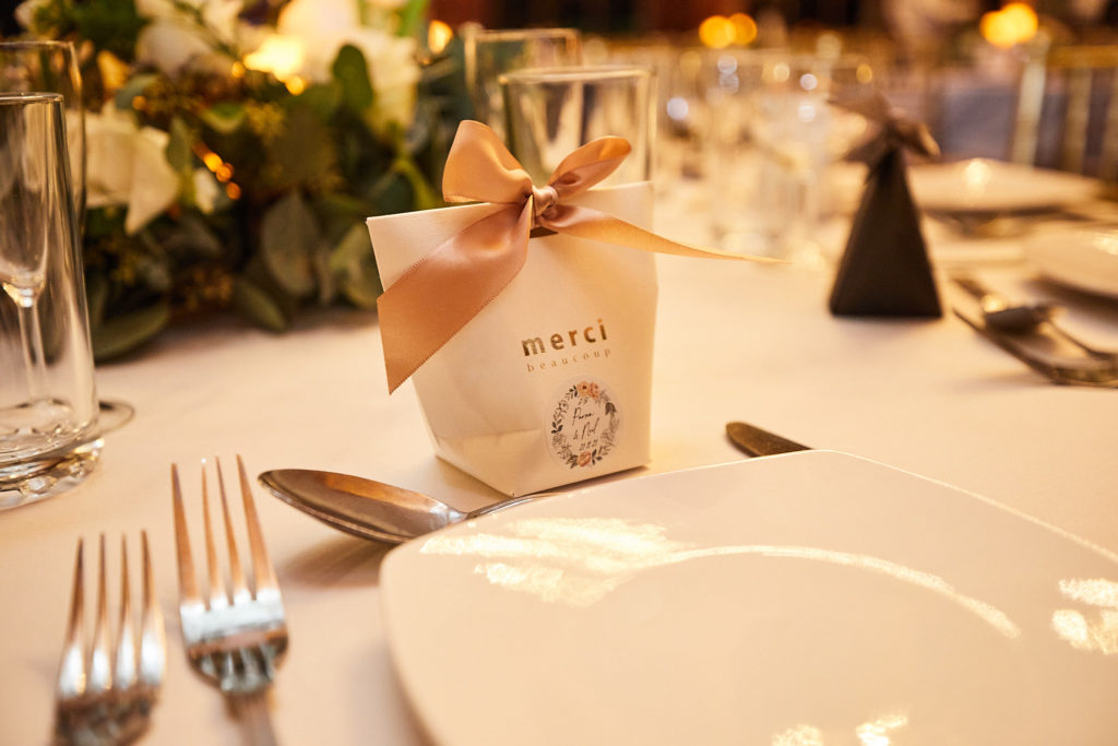 Wedding favour box tied with a ribbon at a place setting