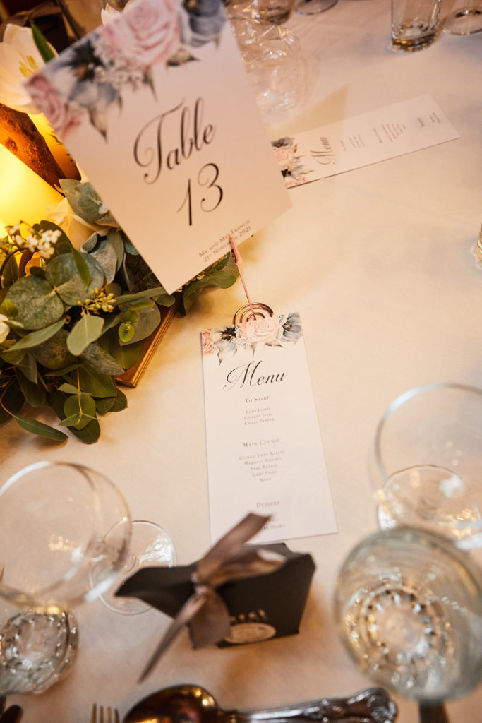 Table number, menu card and favour box on the wedding table