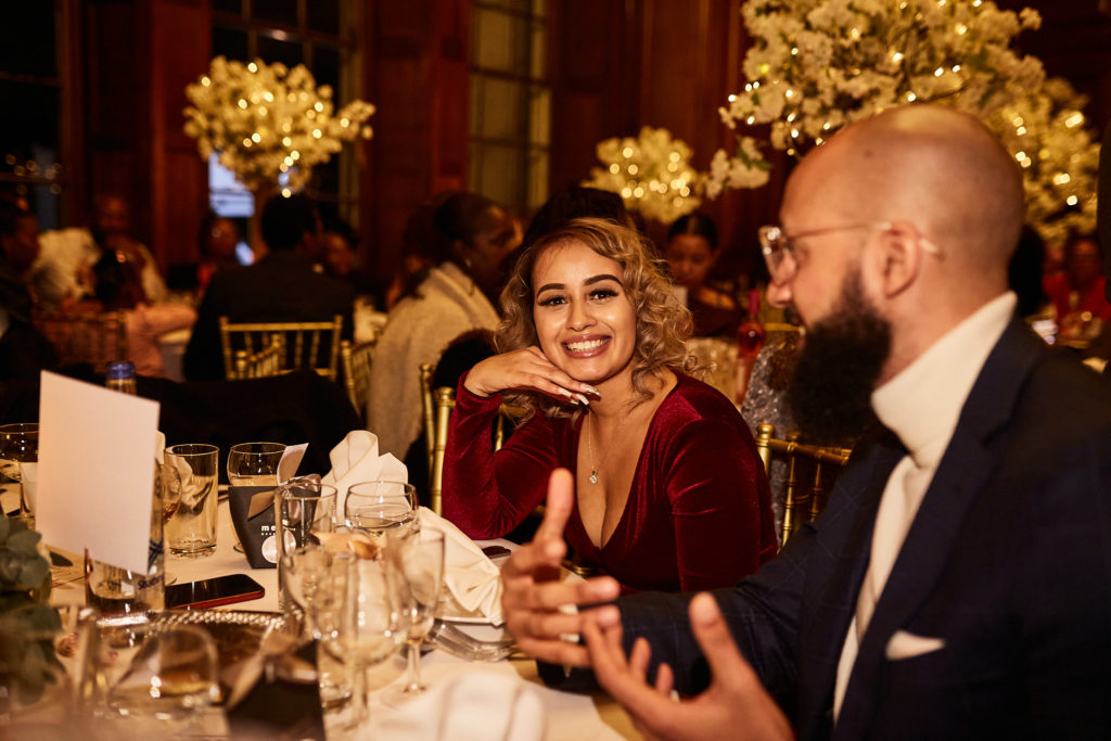 Wedding guests laughing together at their table