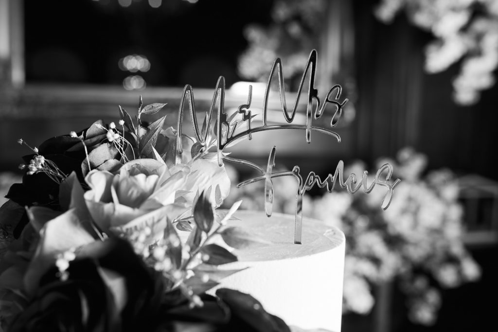 Black and white close-up of the wedding cake topper