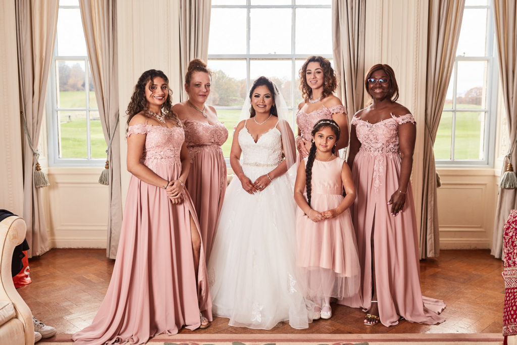 Bride with her bridesmaids and flower girl in the bridal suite