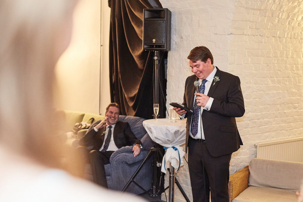 Groom giving his speech with a microphone
