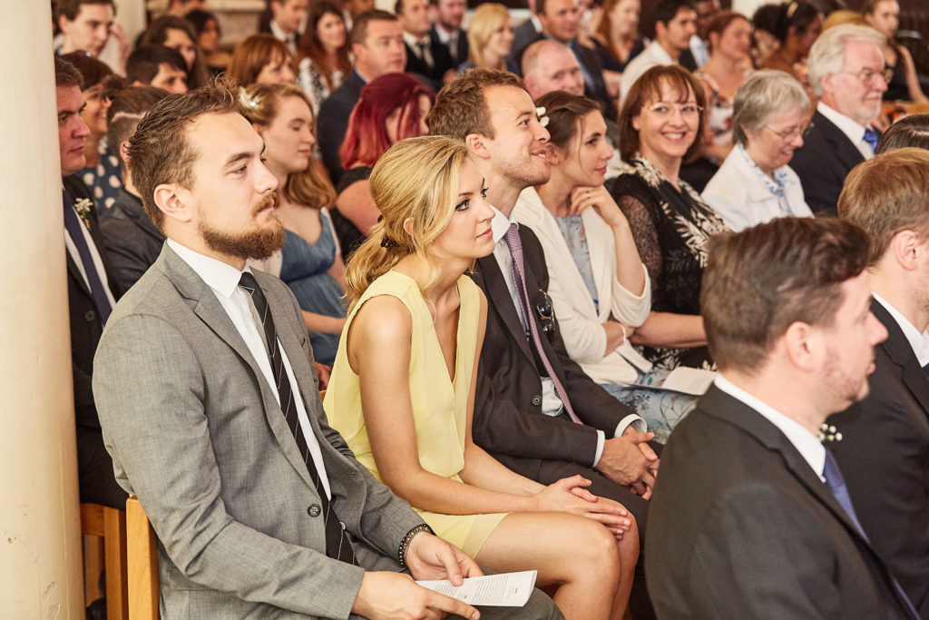 Wedding guests seated in the church during the ceremony
