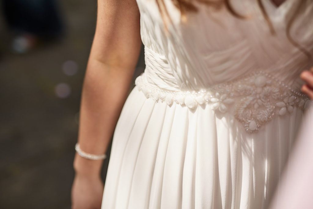 Close-up of the beaded waist of the bride's wedding dress
