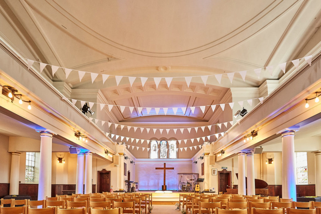 Church interior decorated with bunting for the wedding