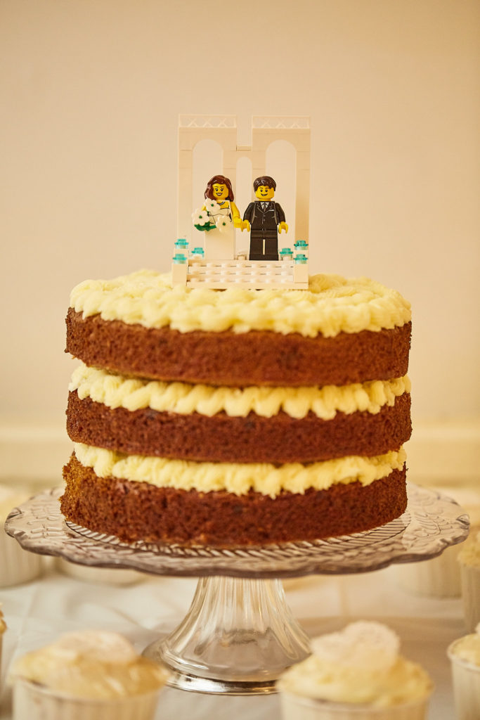 Naked wedding cake topped with Lego bride and groom figures