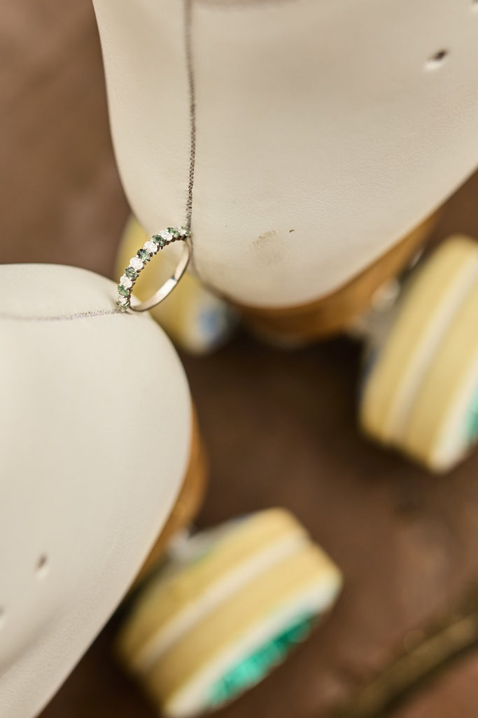 Close-up of a wedding ring balanced on the wheels of a white roller skate