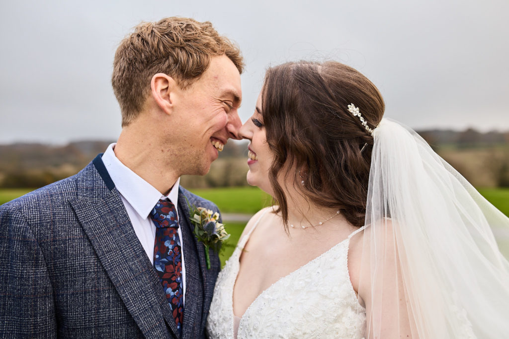 Close-up of the bride and groom smiling nose to nose at Crondon Park, Essex
