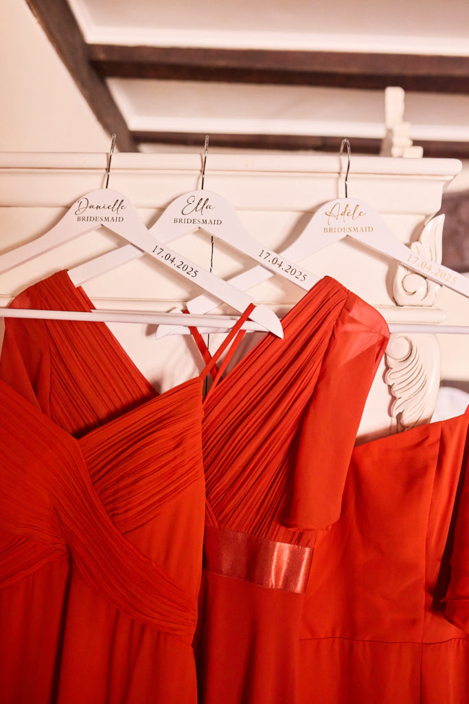 Red bridesmaid dresses on personalised wooden hangers