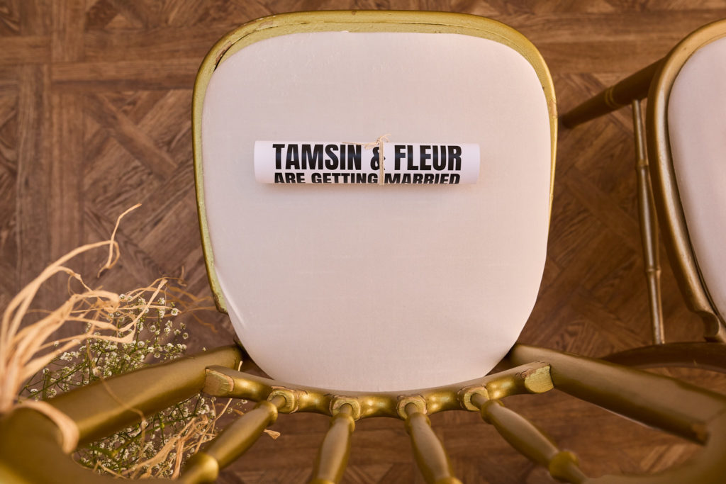 Newspaper-style order of the day on a gold ceremony chair