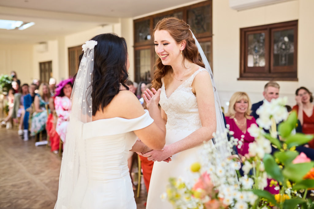 Bride reading her vows as guests watch