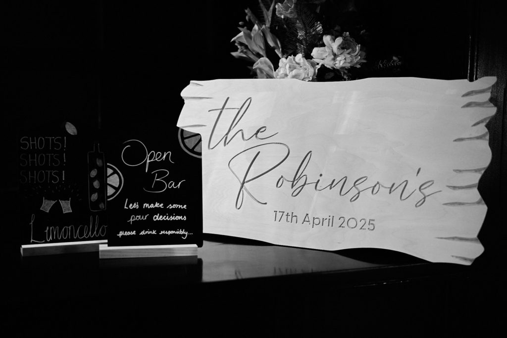 Black and white photo of the wedding welcome sign for "The Robinsons"