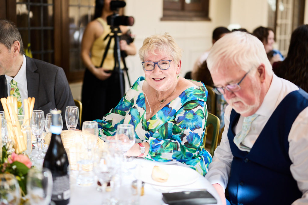 Older guests smiling at the table during the wedding breakfast