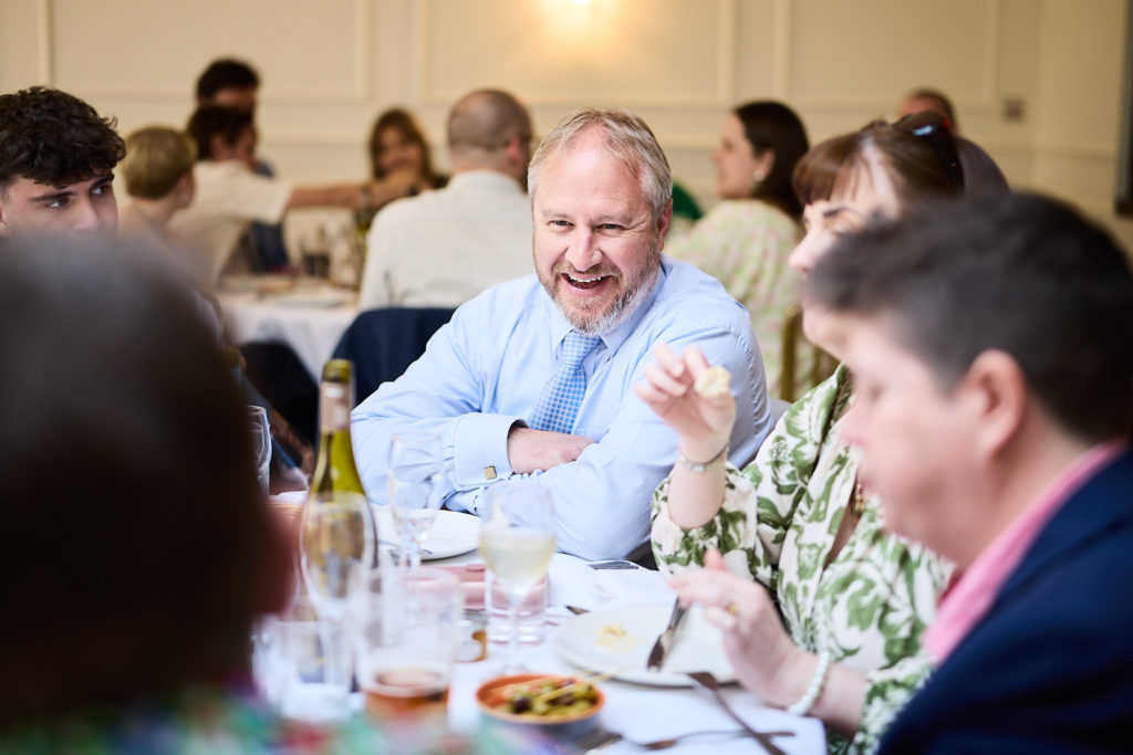 Wedding guests laughing at the table