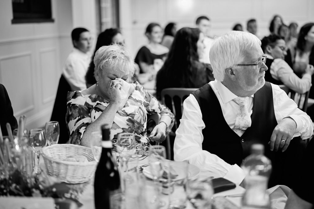 Black and white photo of guests listening to the speeches