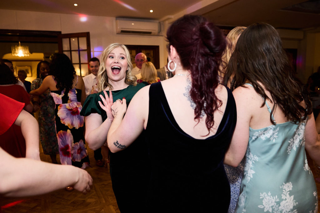 Wedding guests laughing on the dance floor