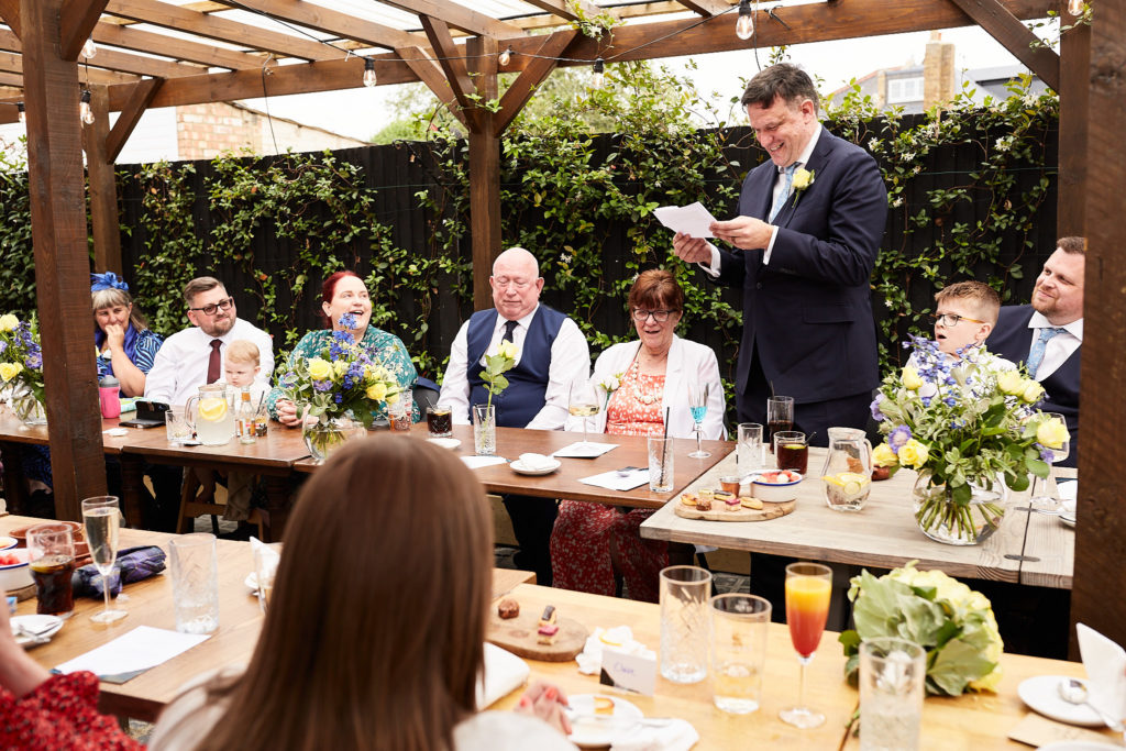 Groom reading his speech to guests at the wedding breakfast