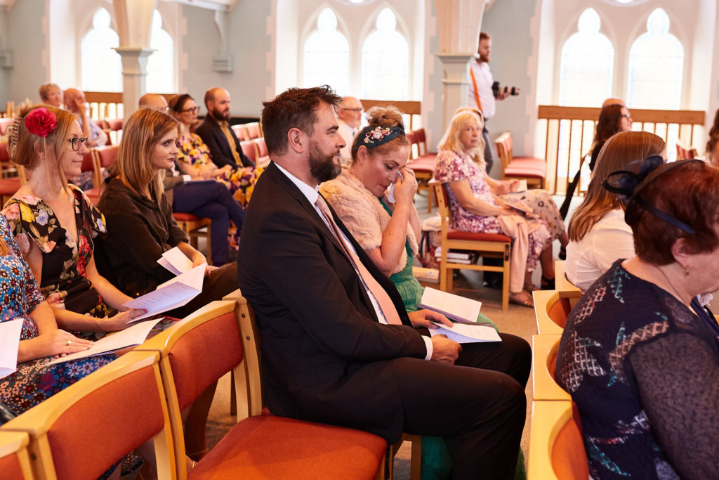 Wedding guests seated in the church before the ceremony