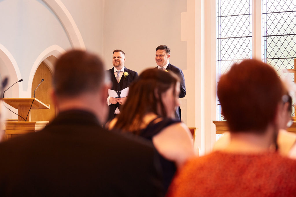 Guests watching the ceremony from their seats in the church