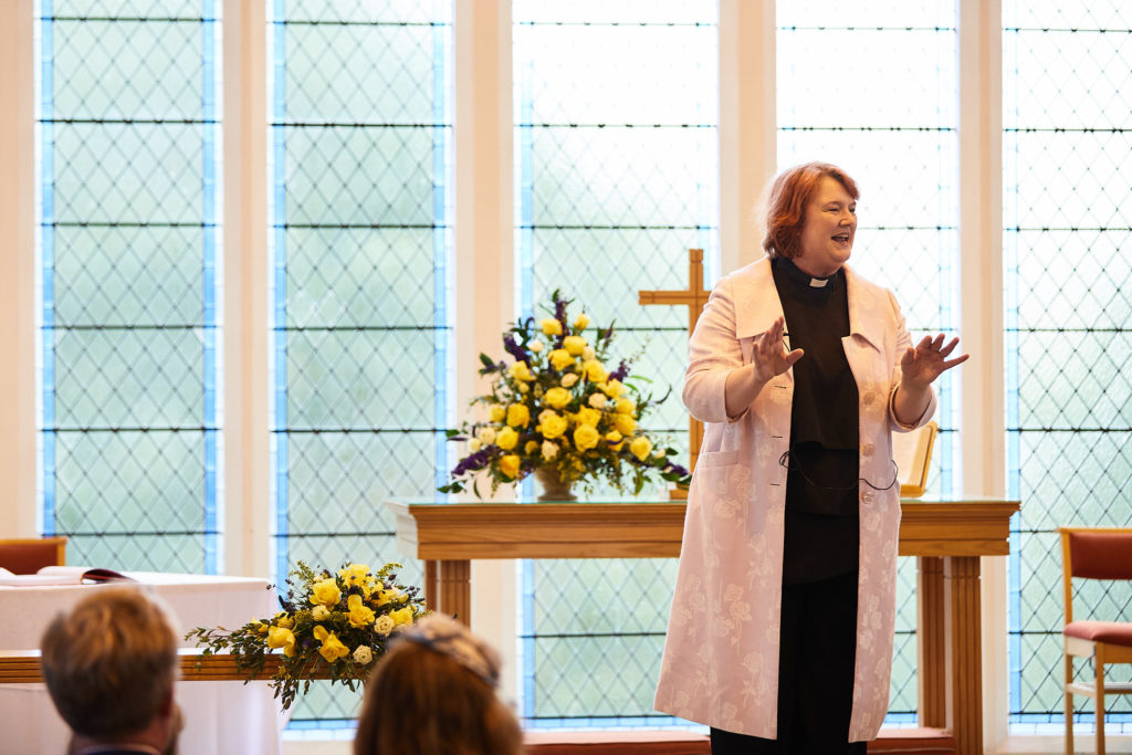 Minister welcoming guests at the start of the wedding ceremony