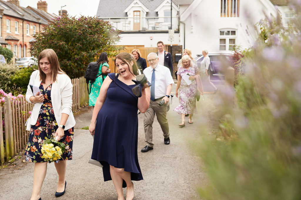 Wedding guests walking along the street to the reception