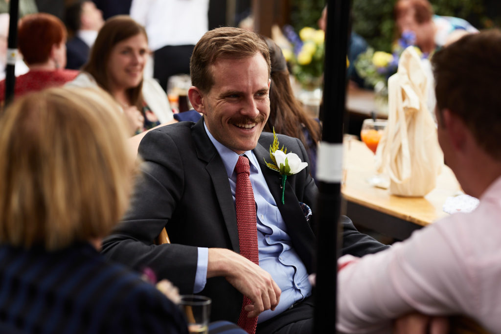 Wedding guest laughing at the table