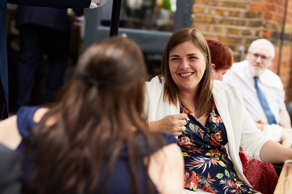 Wedding guest smiling during the speeches