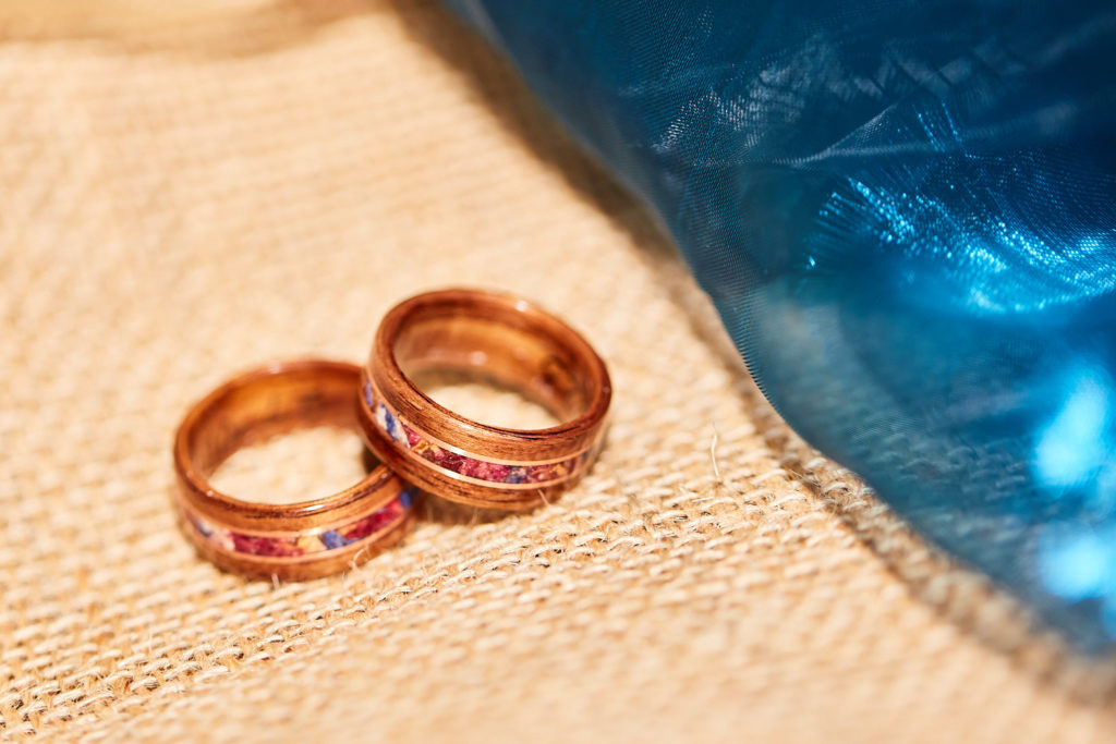 Two rose gold wedding rings on hessian