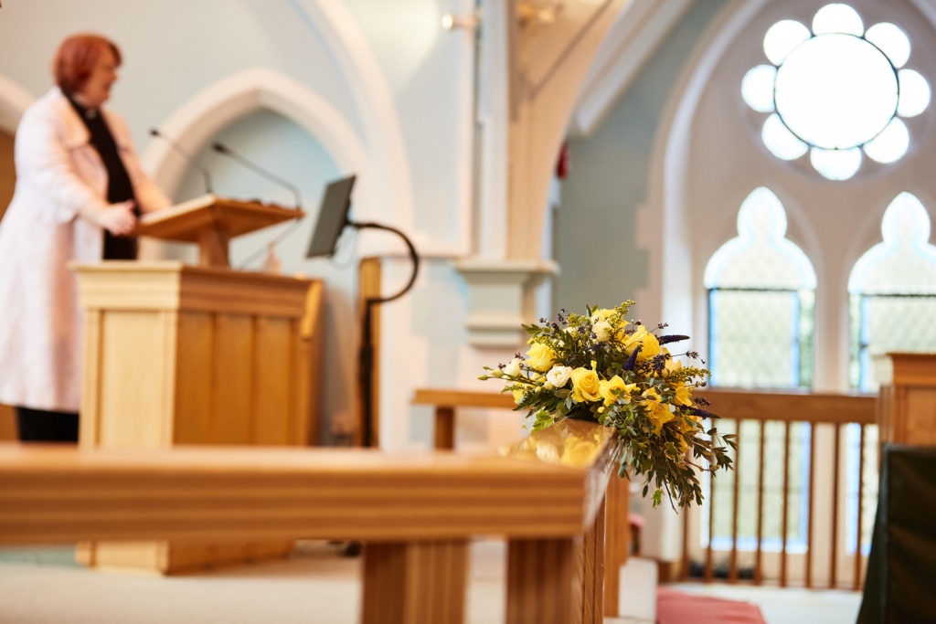 Minister speaking from the lectern during the wedding ceremony