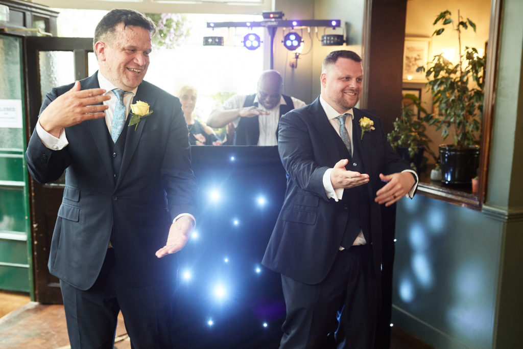 Two grooms dancing together at their LGBT wedding reception