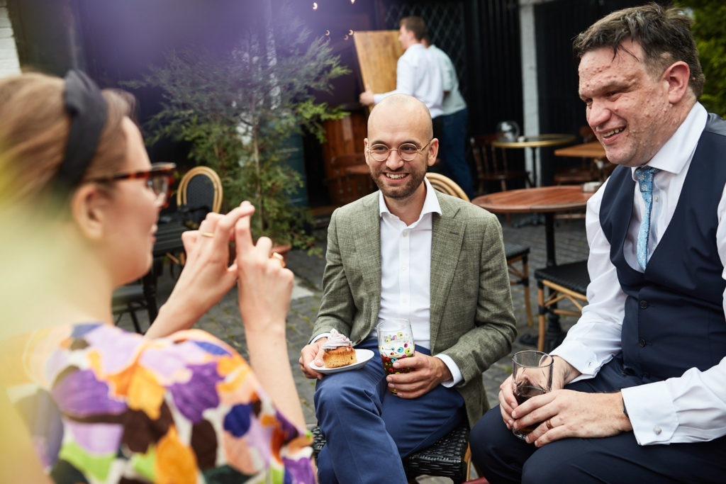 Groom chatting with guests in the garden